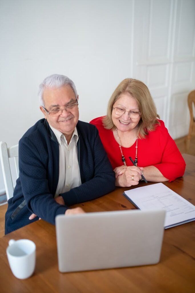 Elderly Couple Looking at a Laptop